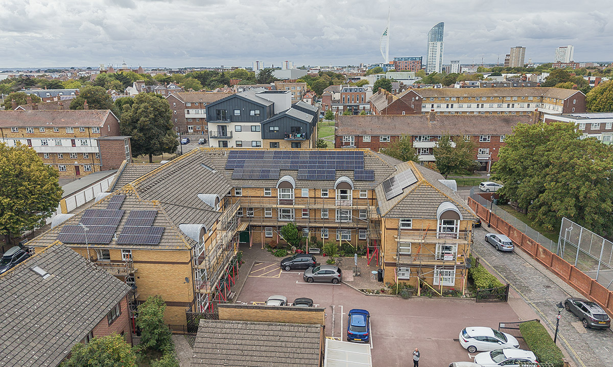 Aerial view of the scaffolded block with the Portsmouth skyline and Spinnaker Tower behind