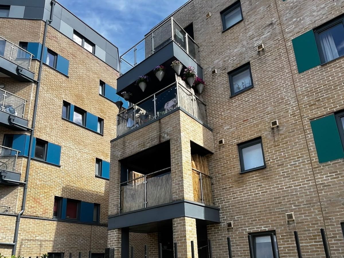 The same balcony stack on Thames Street after the works, scaffold struck and the balconies back in use