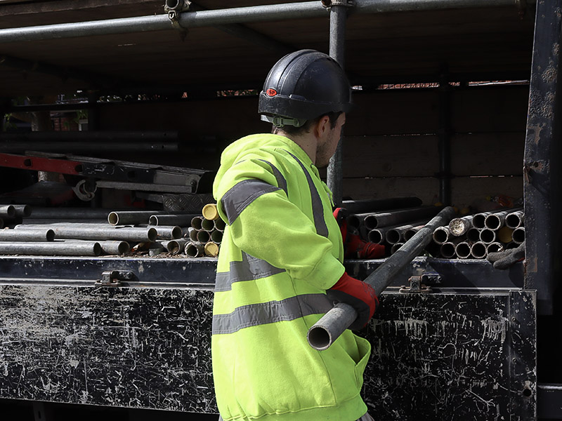A BSL scaffolder drawing tube from the loaded lorry bed